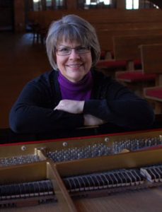 Janet Johnson sitting at the piano