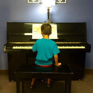 photo of a young boy sitting at the piano