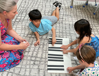 Students on the floor with piano keys layout